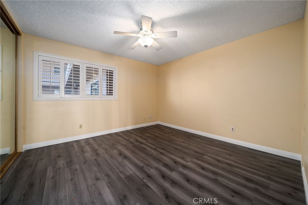 1311 South Grand Avenue, Unit 5 San Pedro, CA 90731 - Photo 10 of 20 a view of an empty room with wooden floor and a window