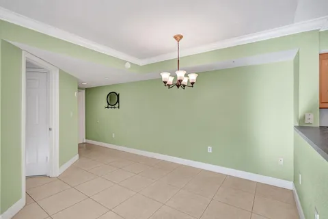 a view of a kitchen with a cabinet and a chandelier