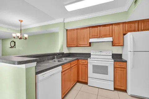 a kitchen with a sink stove and refrigerator