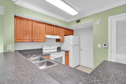a kitchen with a refrigerator and a sink