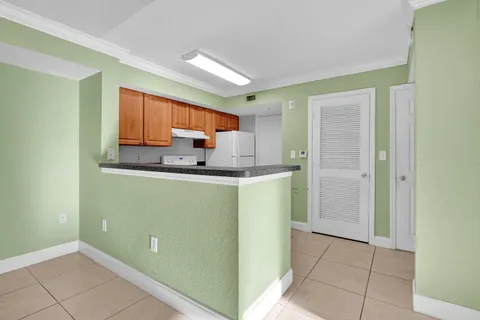 a kitchen with stainless steel appliances granite countertop a refrigerator sink and cabinets