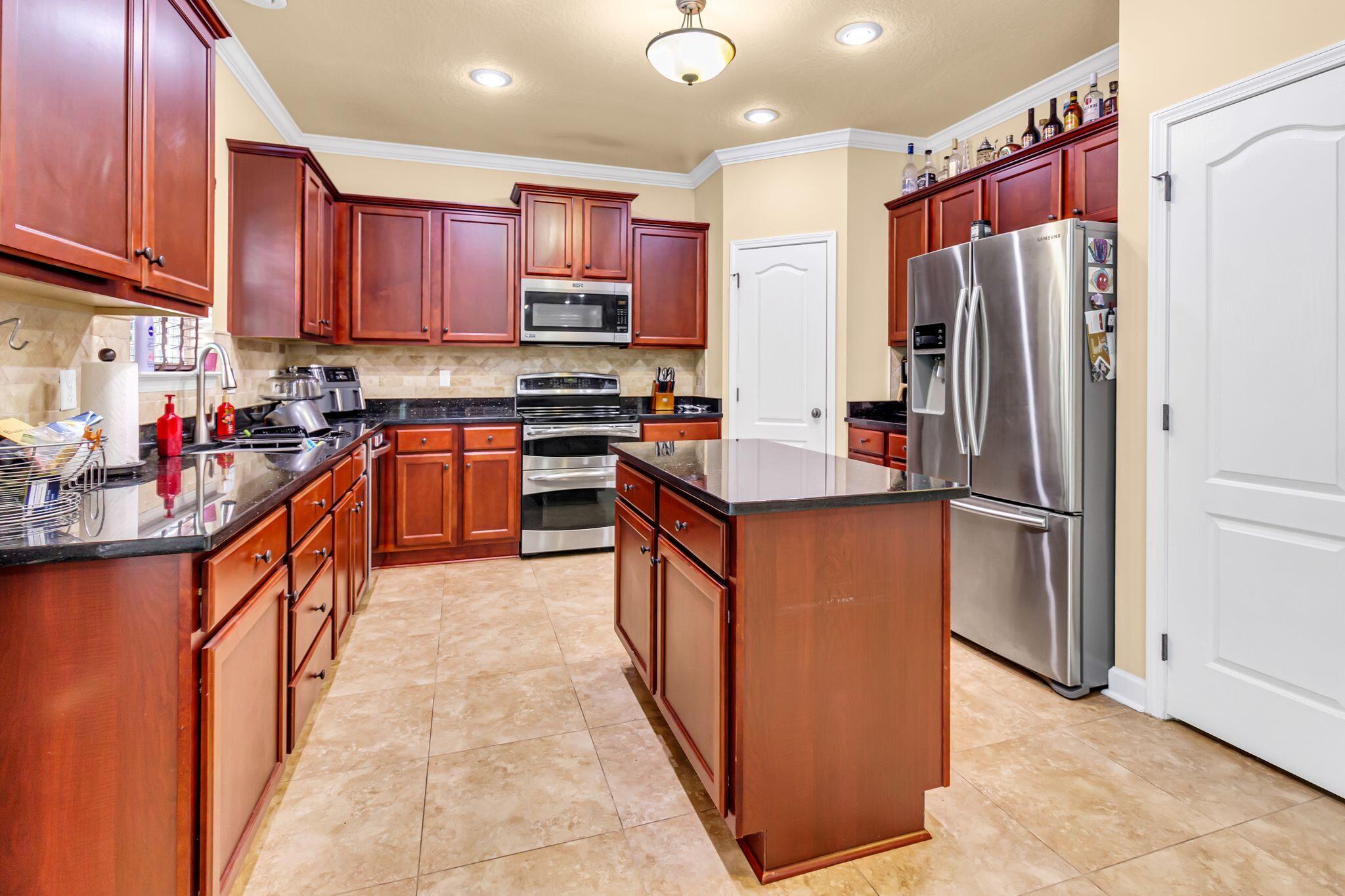 4558 Hermosa Road Crestview, FL 32539 - Photo 12 of 50 a kitchen with stainless steel appliances granite countertop refrigerator a sink and dishwasher