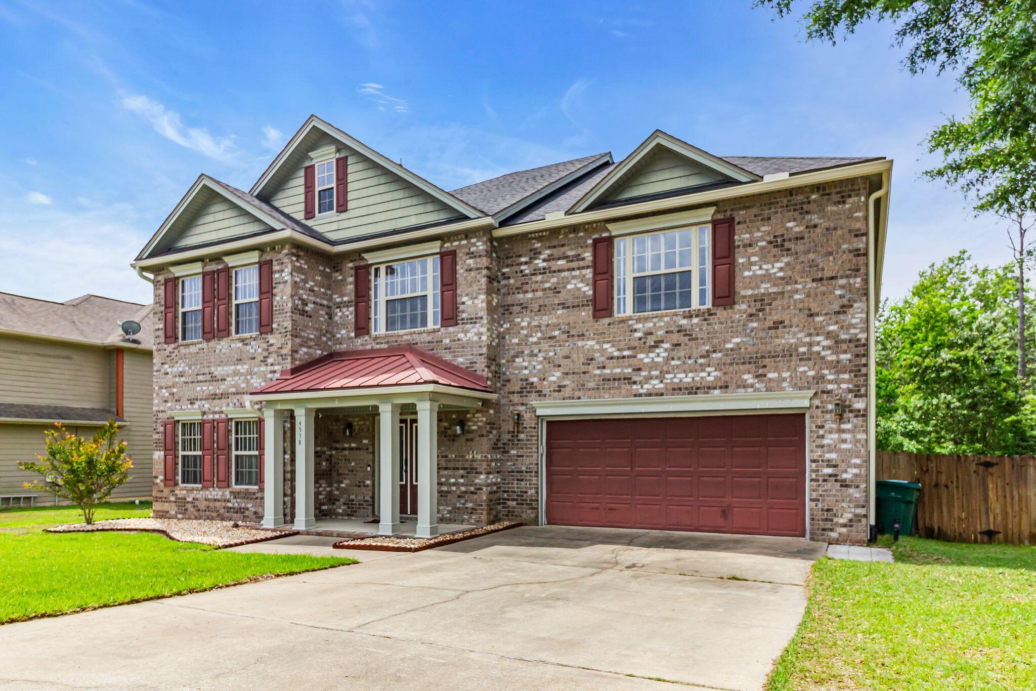 4558 Hermosa Road Crestview, FL 32539 - Photo 2 of 50 a front view of a house with garden