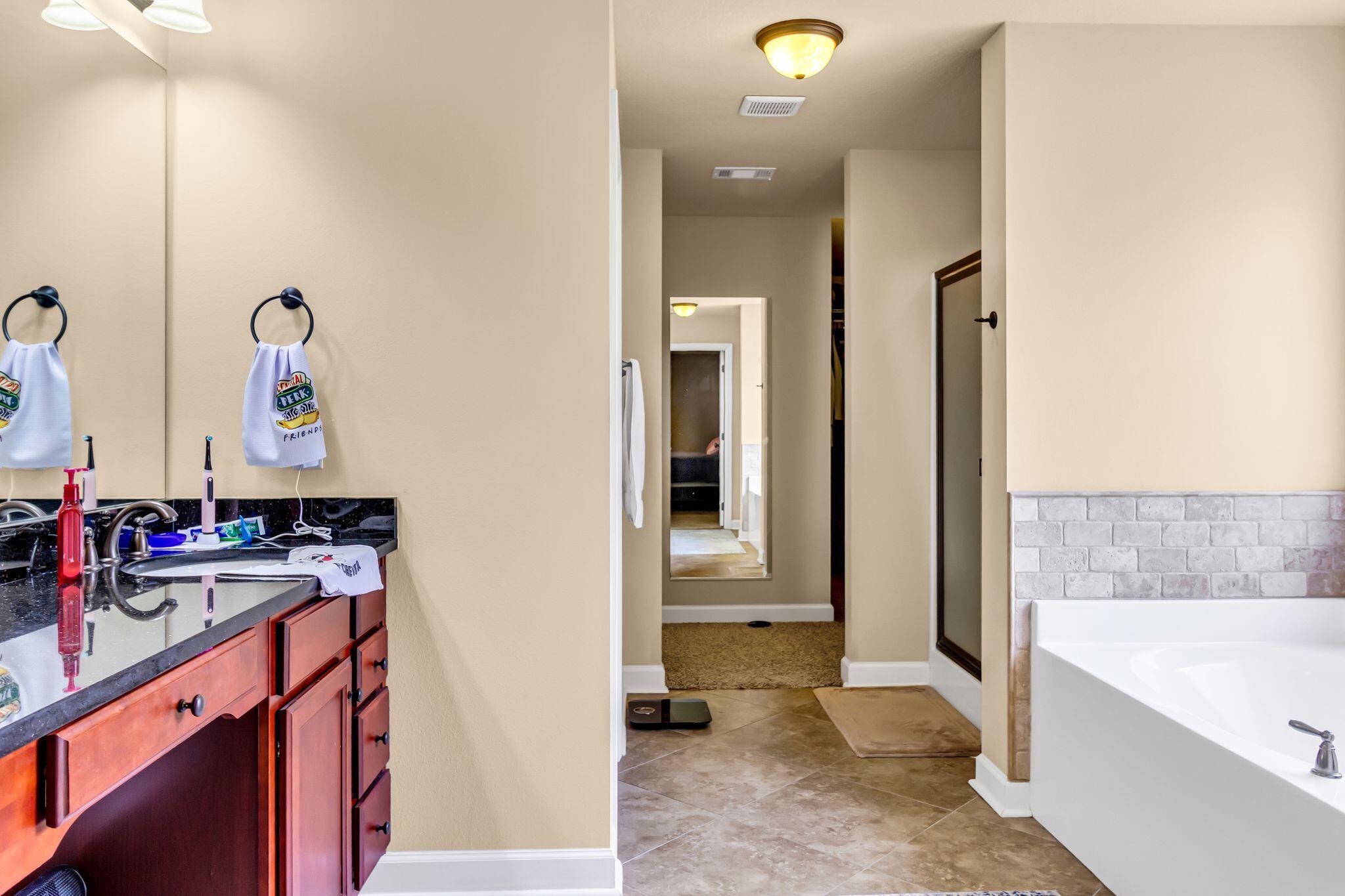 4558 Hermosa Road Crestview, FL 32539 - Photo 27 of 50 a bathroom with a sink double vanity and a bathtub
