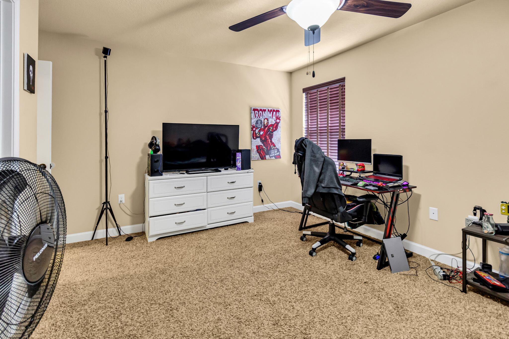 4558 Hermosa Road Crestview, FL 32539 - Photo 34 of 50 a view of a workspace with furniture and a flat screen tv