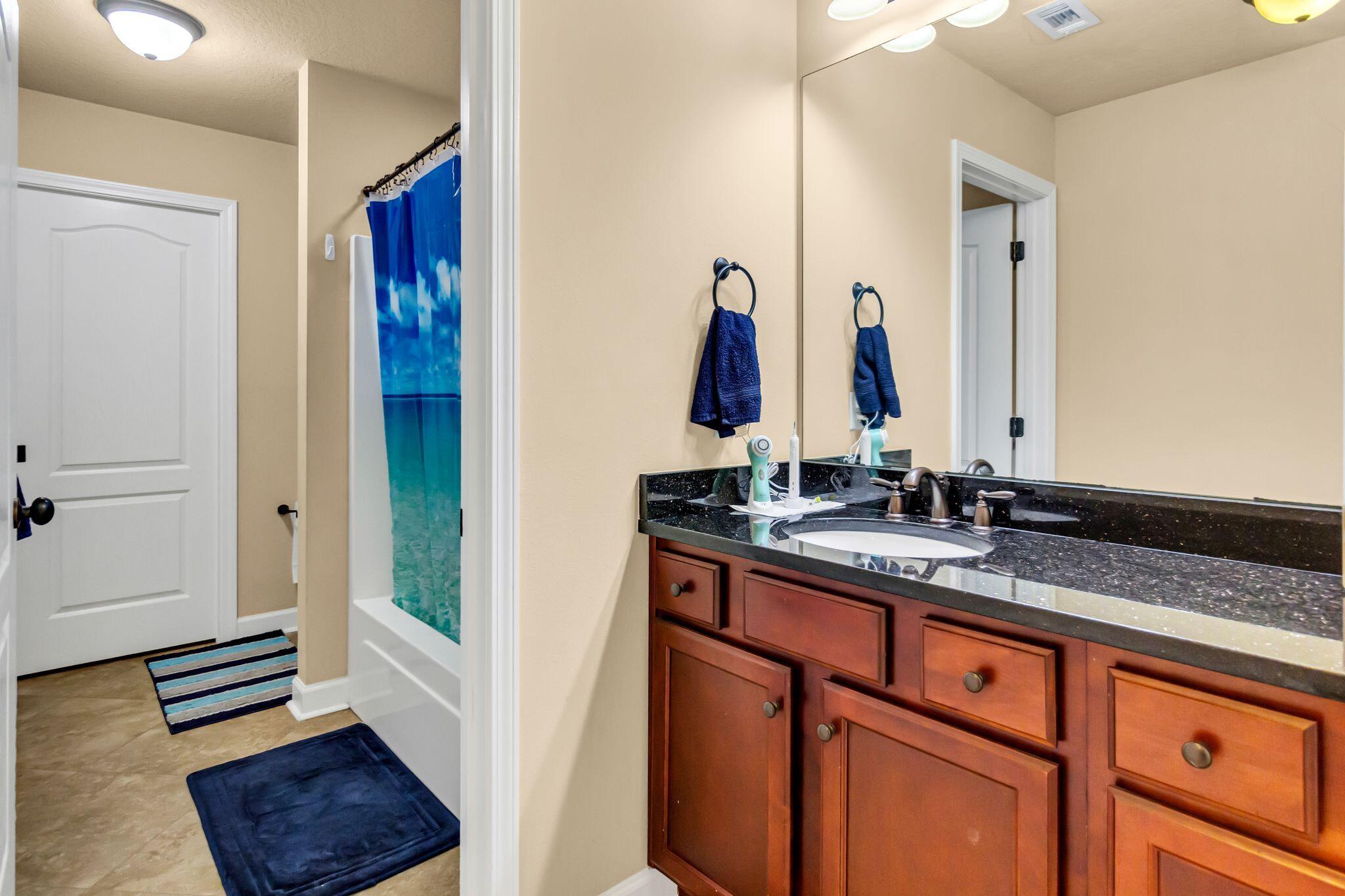 4558 Hermosa Road Crestview, FL 32539 - Photo 35 of 50 a bathroom with a sink and a mirror