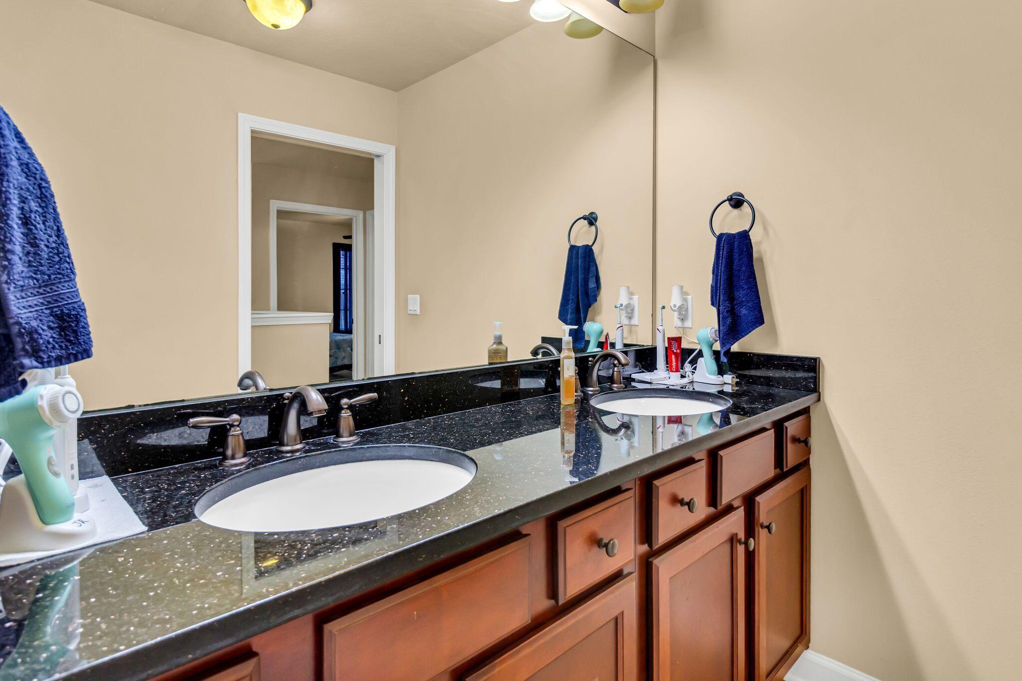 4558 Hermosa Road Crestview, FL 32539 - Photo 37 of 50 a bathroom with double vanity sinks and a mirror