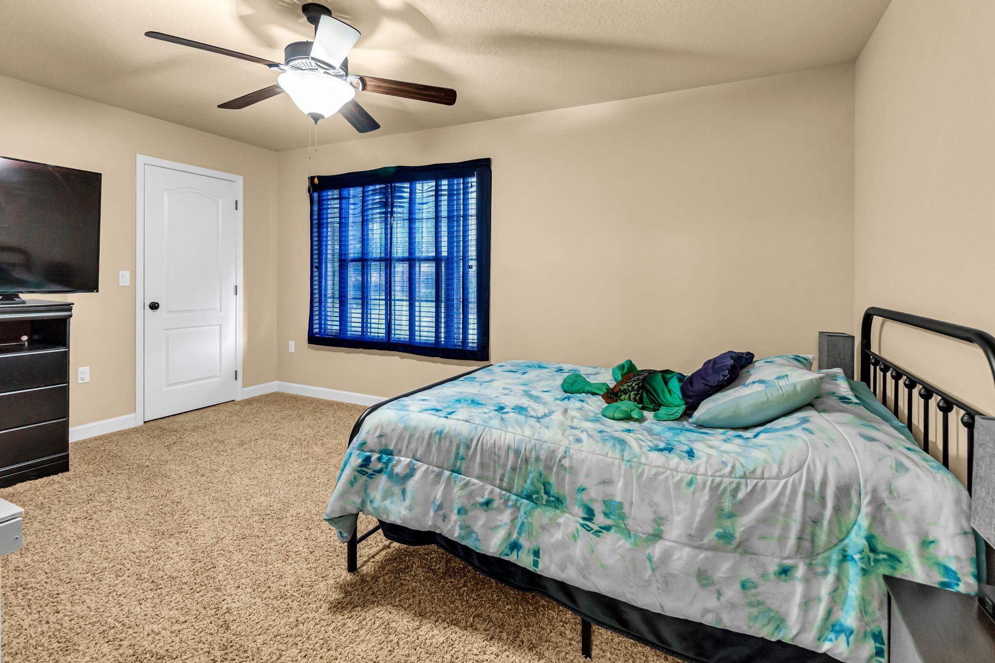 4558 Hermosa Road Crestview, FL 32539 - Photo 39 of 50 a bedroom with a bed window and a flat screen tv