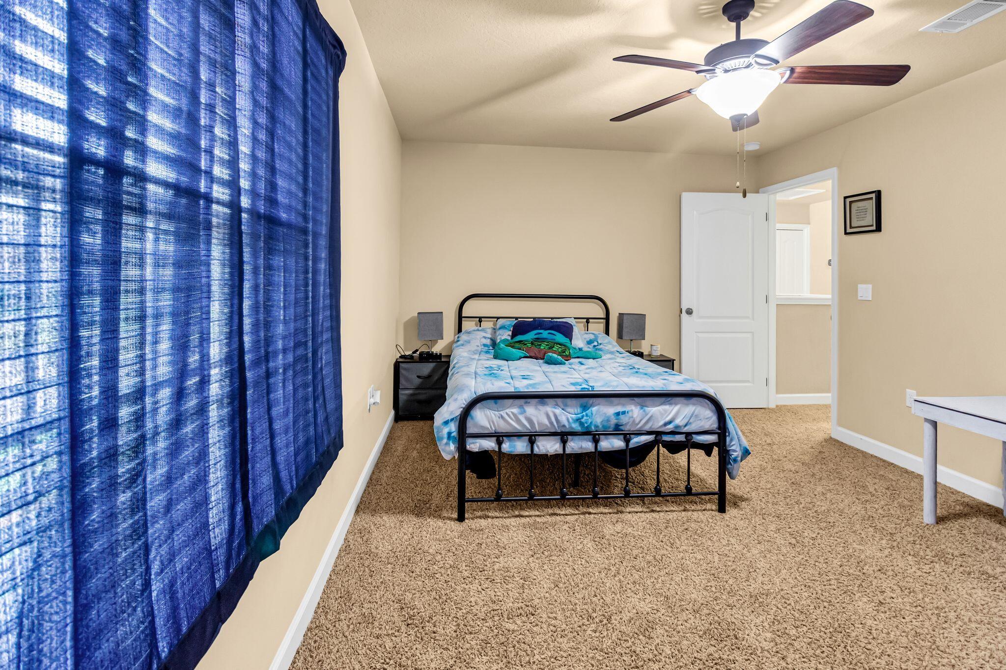 4558 Hermosa Road Crestview, FL 32539 - Photo 41 of 50 a bedroom with a bed and a chandelier