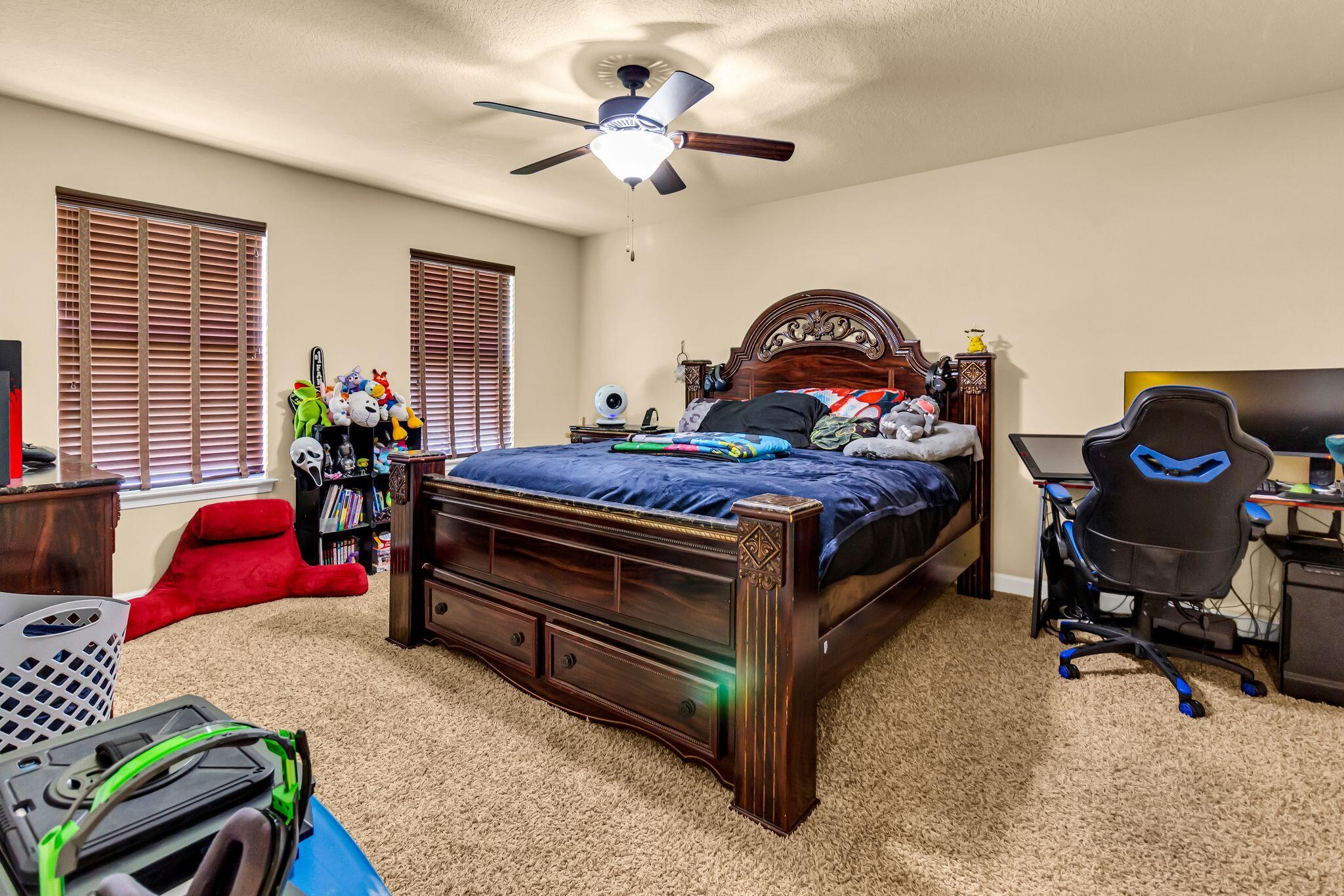 4558 Hermosa Road Crestview, FL 32539 - Photo 44 of 50 a bedroom with a bed and a chandelier