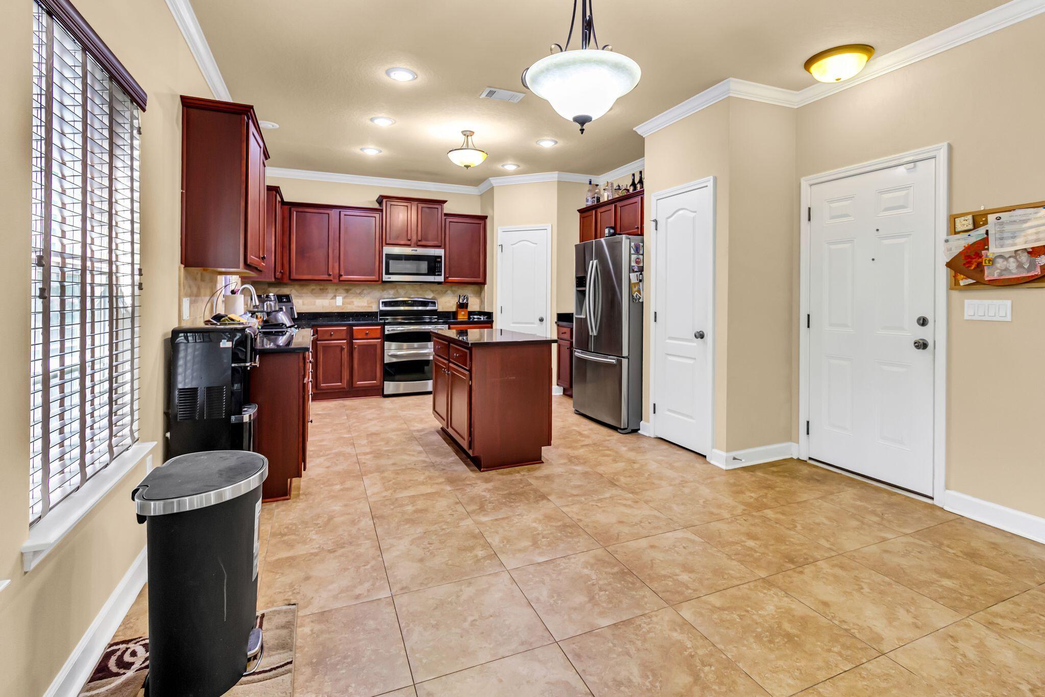 4558 Hermosa Road Crestview, FL 32539 - Photo 10 of 50 a kitchen with stainless steel appliances granite countertop a sink dishwasher stove and refrigerator