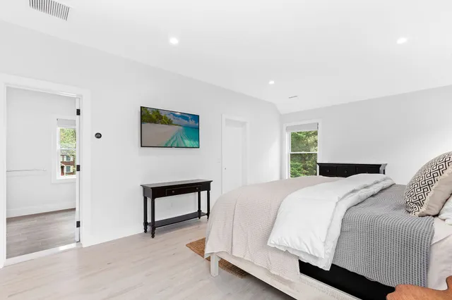 a bedroom with a bed and a painting