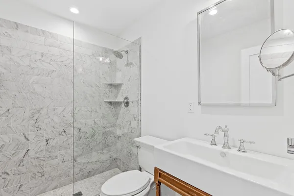 a bathroom with a sink toilet and shower