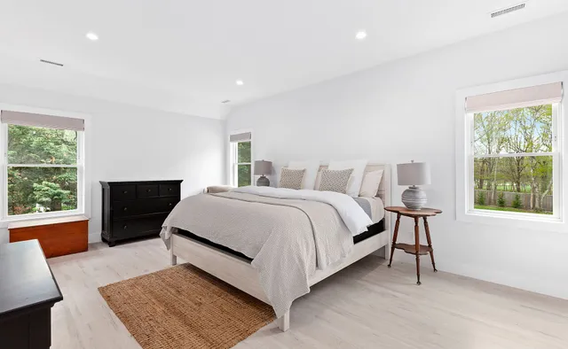 a bed room with a bed and a large window