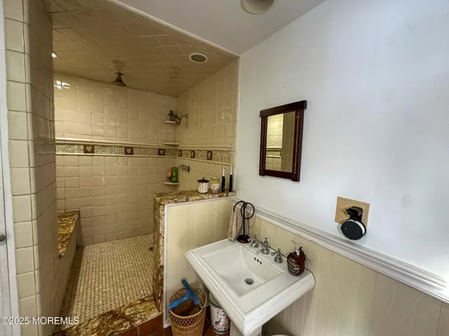 a bathroom with a sink mirror and toilet