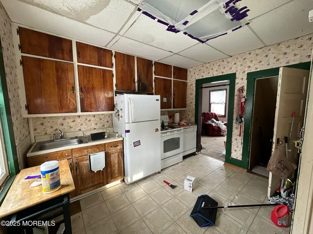 a kitchen with stainless steel appliances granite countertop a sink refrigerator and stove