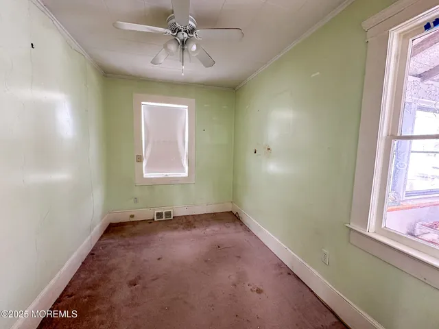 a view of empty room with windows