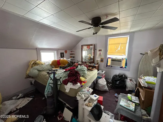 a living room with furniture a window and gym equipment