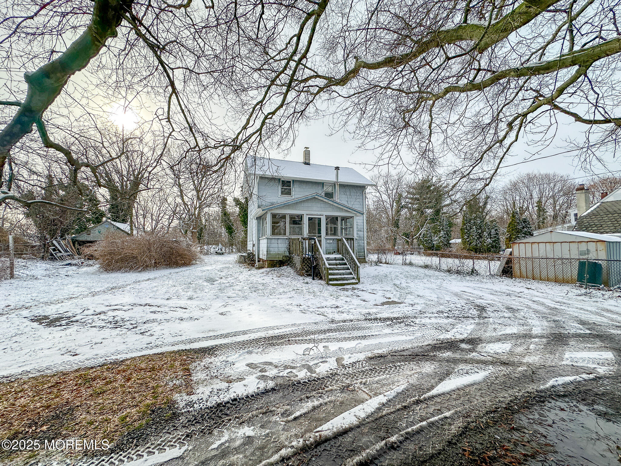 80 Atlantic Avenue Long Branch, NJ 07740 - Photo 22 of 31 a view of a house with a yard covered in snow