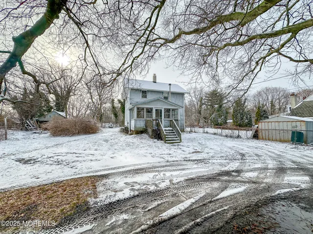 a view of a house with a yard covered in snow
