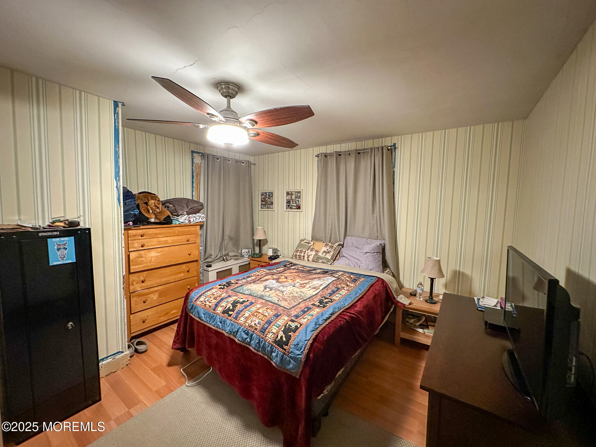 80 Atlantic Avenue Long Branch, NJ 07740 - Photo 7 of 31 a bed room with a bed and a television