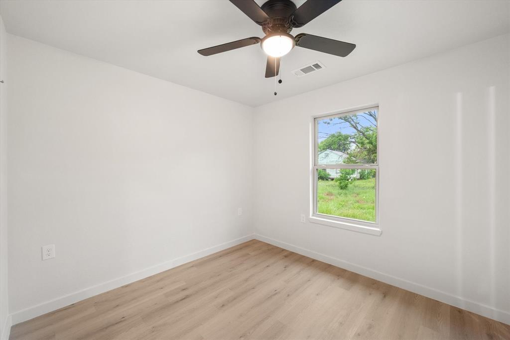 901 South 3rd Dawson, TX 76639 - Photo 17 of 32 an empty room with a window and a ceiling fan