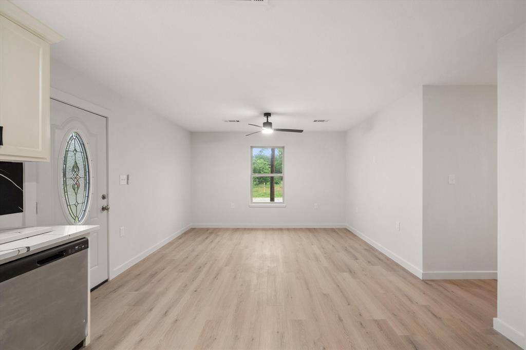 901 South 3rd Dawson, TX 76639 - Photo 3 of 32 an empty room with window and wooden floor