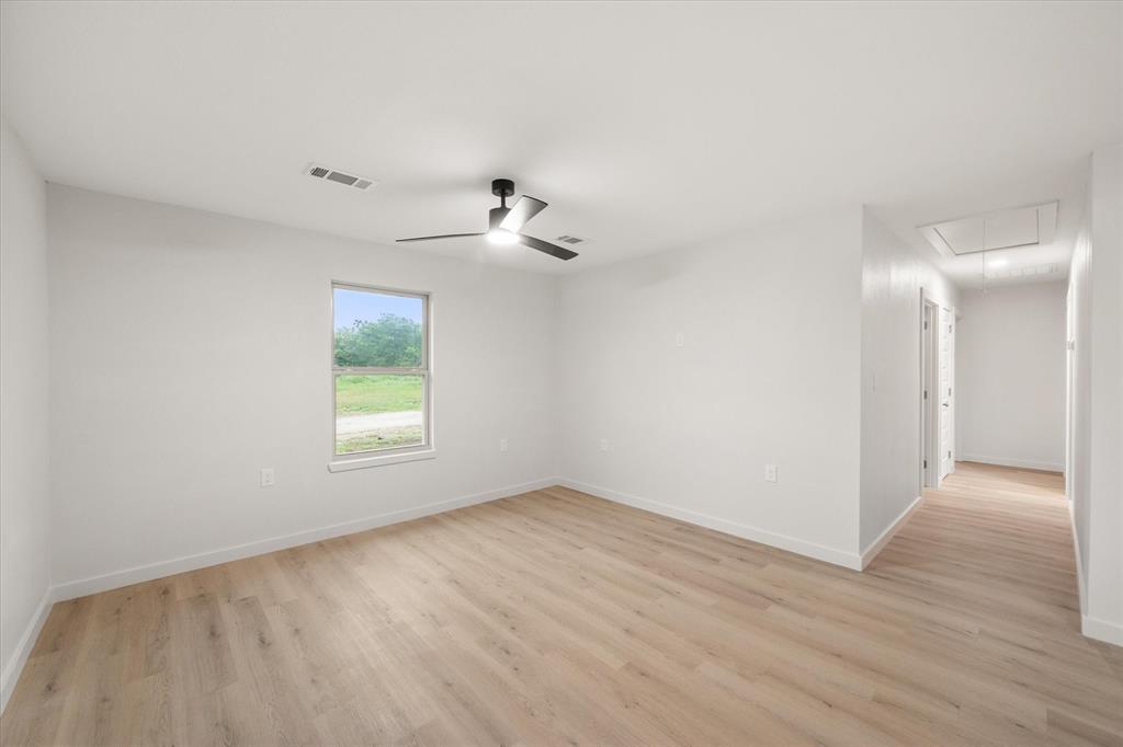 901 South 3rd Dawson, TX 76639 - Photo 4 of 32 wooden floor in an empty room with a window