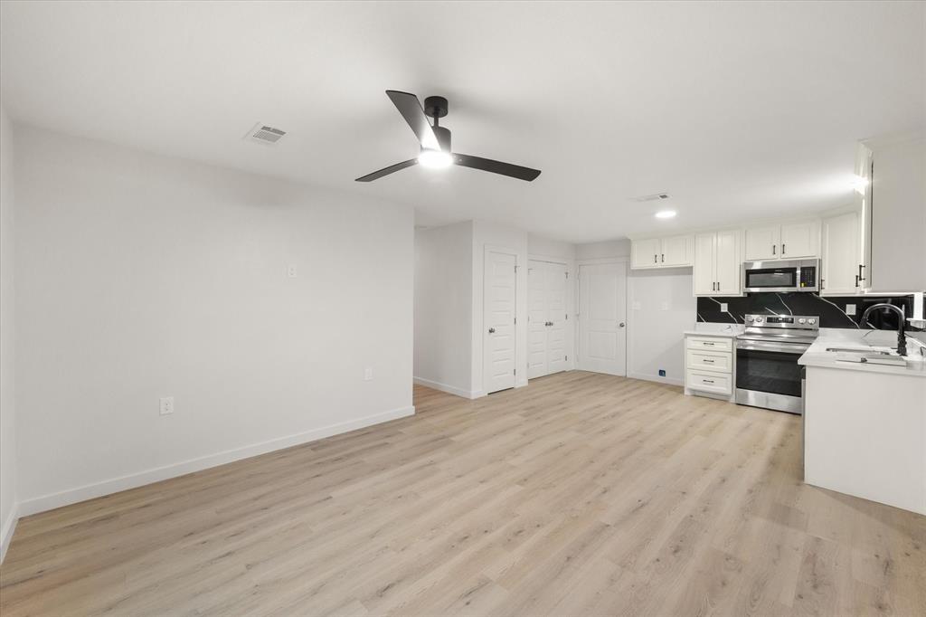 901 South 3rd Dawson, TX 76639 - Photo 5 of 32 a view of a kitchen with a sink and dishwasher a refrigerator with wooden floor
