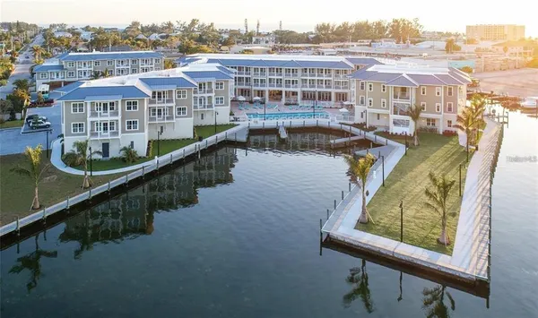 a view of a building with backyard and sitting area