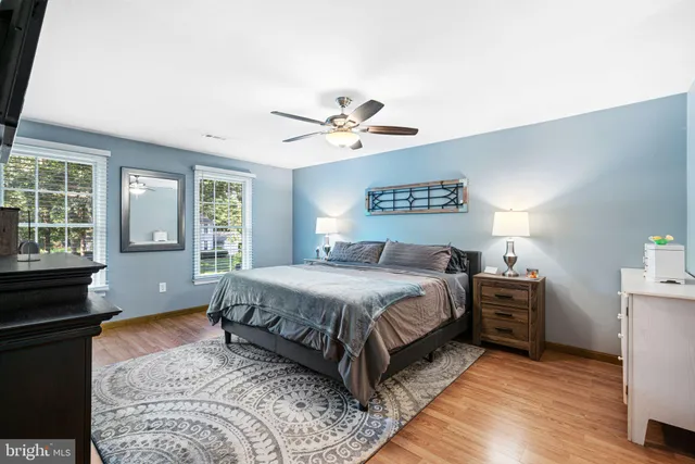 a spacious bedroom with a bed and a chandelier