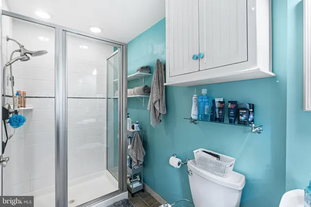 a bathroom with a toilet a sink and shower