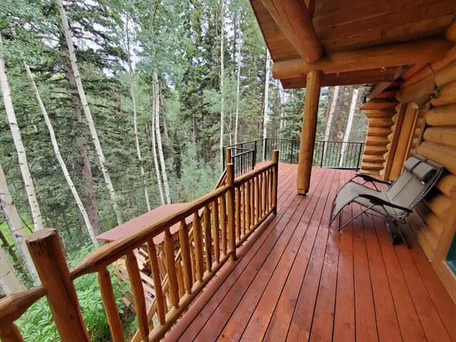 a view of balcony with wooden floor and fence