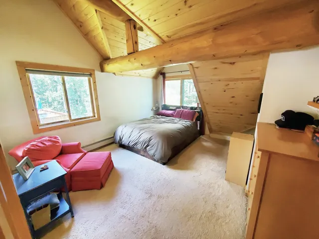 a bedroom with furniture and a window