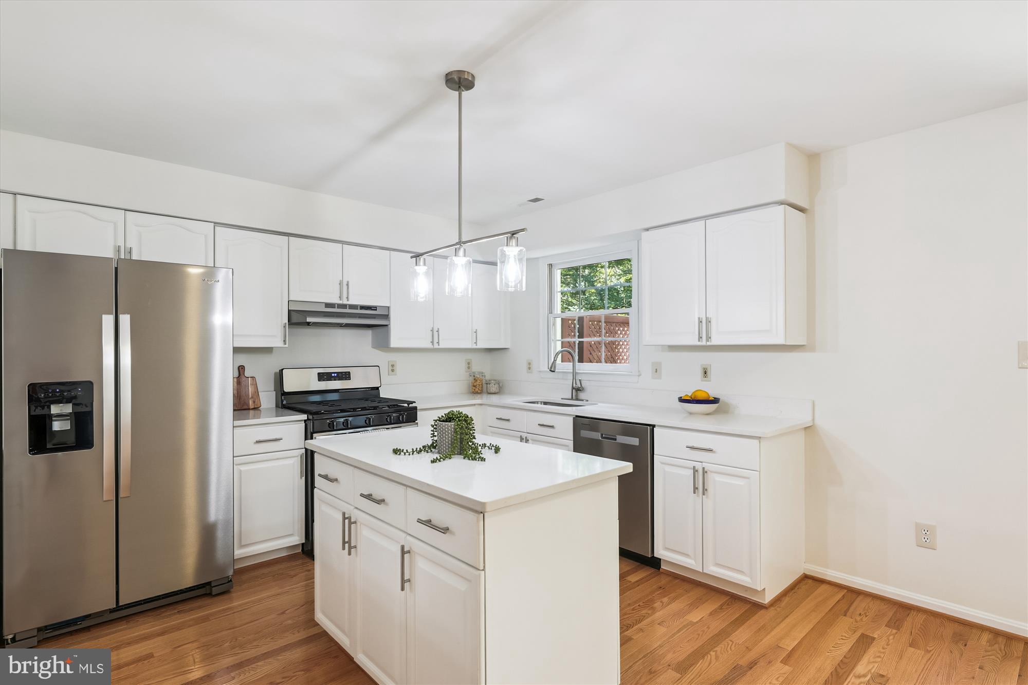 8840 Eagle Rock Lane Springfield, VA 22153 - Photo 12 of 52 a kitchen with a sink white cabinets and stainless steel appliances