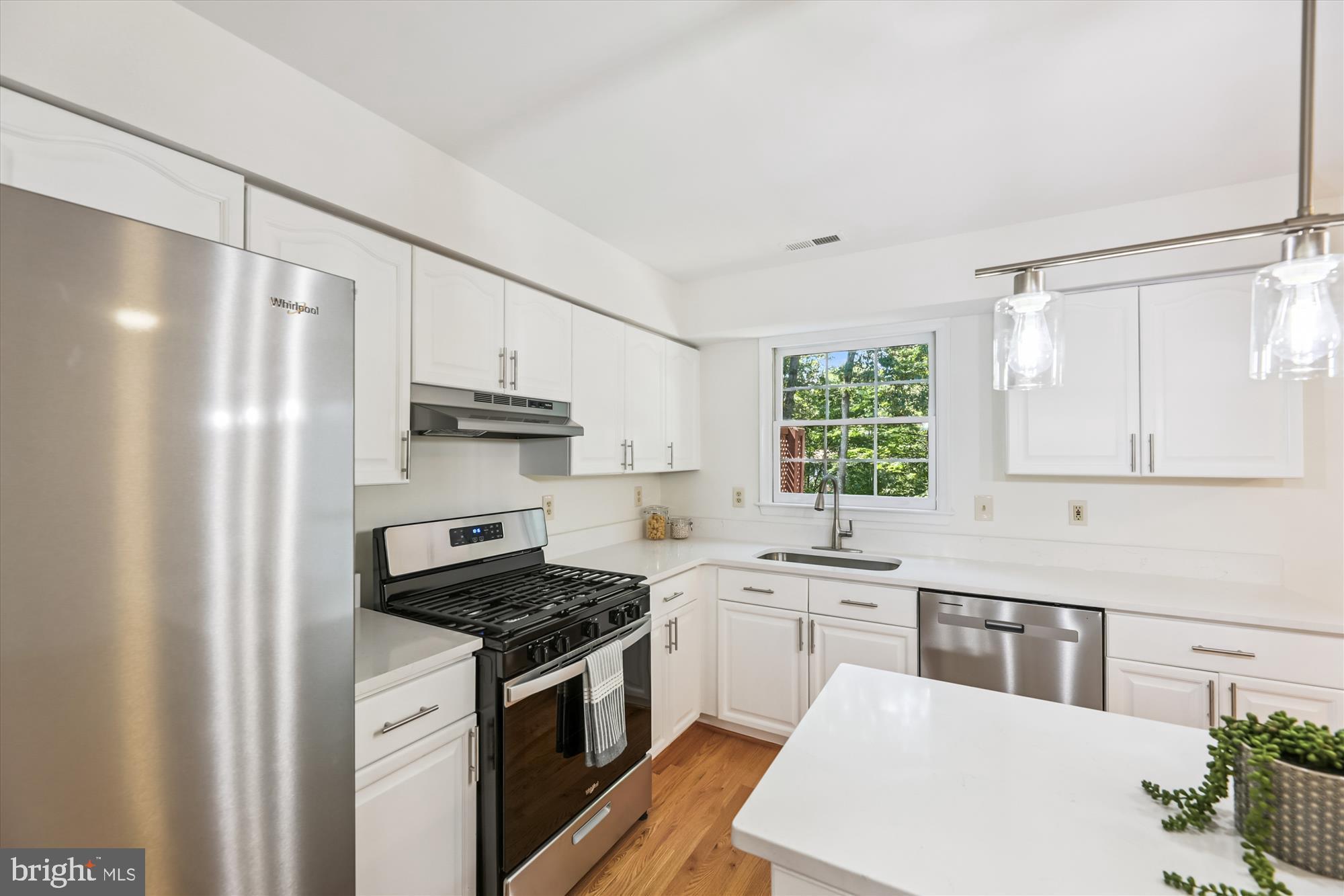 8840 Eagle Rock Lane Springfield, VA 22153 - Photo 14 of 52 a kitchen with stainless steel appliances a sink cabinets and a window