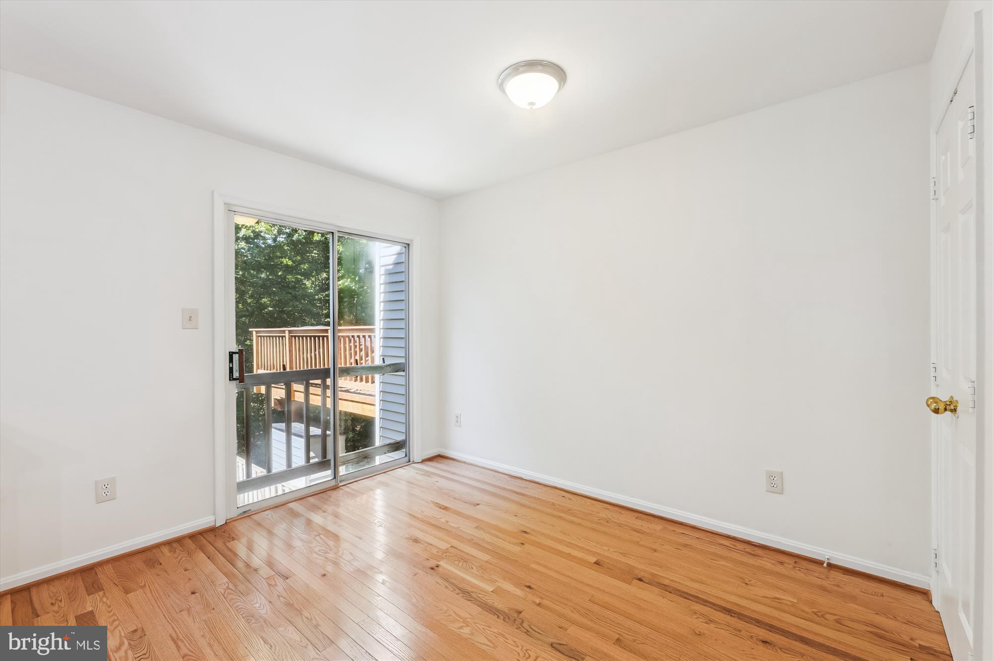 8840 Eagle Rock Lane Springfield, VA 22153 - Photo 17 of 52 an empty room with wooden floor and windows