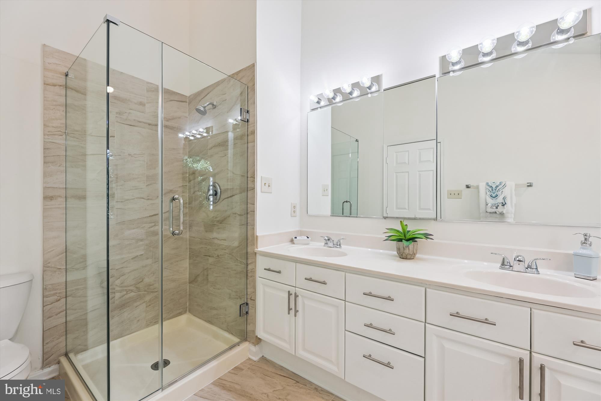8840 Eagle Rock Lane Springfield, VA 22153 - Photo 27 of 52 a bathroom with a shower sink and mirror