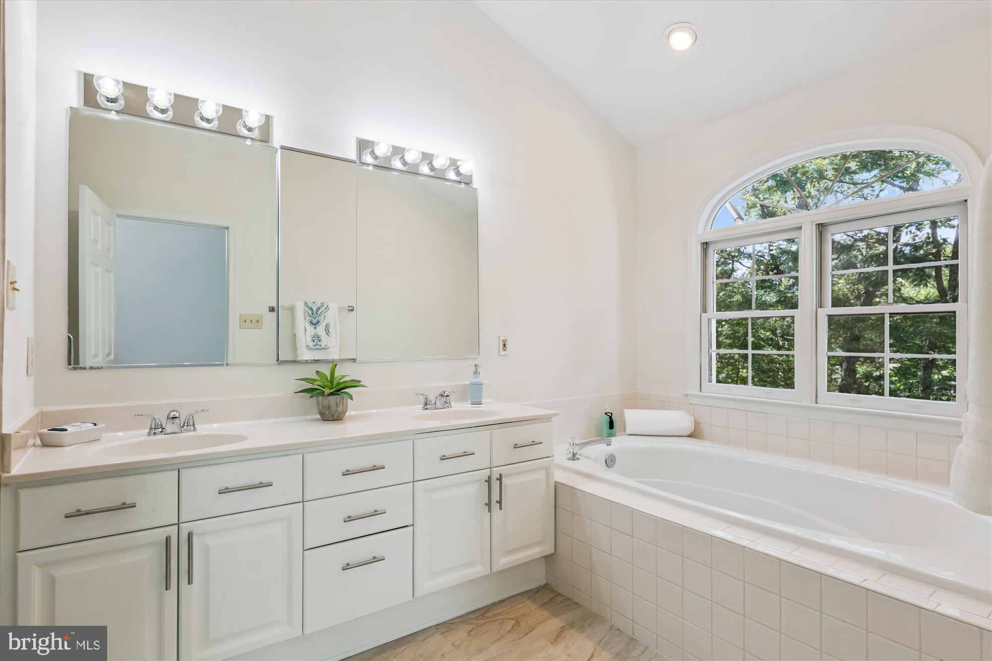 8840 Eagle Rock Lane Springfield, VA 22153 - Photo 28 of 52 a spacious bathroom with a granite countertop sink mirror and a bathtub