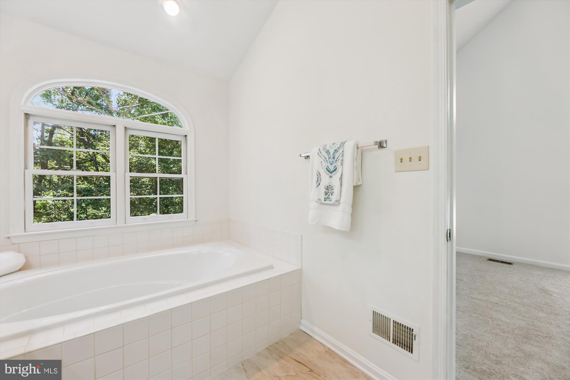 8840 Eagle Rock Lane Springfield, VA 22153 - Photo 29 of 52 a bathroom with a bathtub and a window