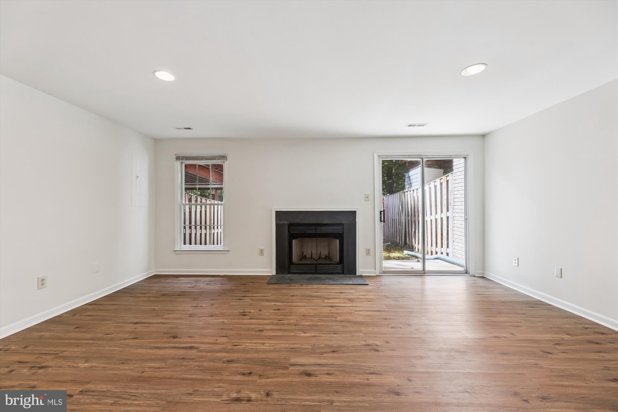 8840 Eagle Rock Lane Springfield, VA 22153 - Photo 38 of 52 wooden floor fireplace and windows in an empty room