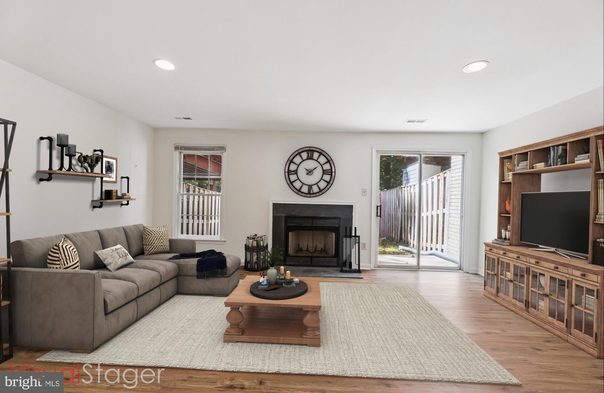 8840 Eagle Rock Lane Springfield, VA 22153 - Photo 39 of 52 a living room with furniture a fireplace and a flat screen tv