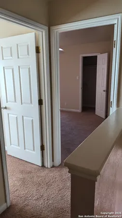 a view of a hallway with wooden floor and entryway