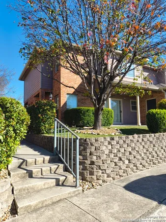 front view of a house with a tree