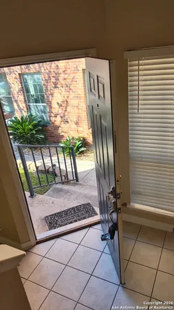 a view of a porch with chairs and backyard