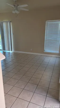 an empty room with wooden floor and cabinet
