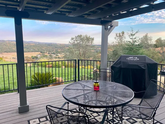 a living room with furniture a rug and a chandelier