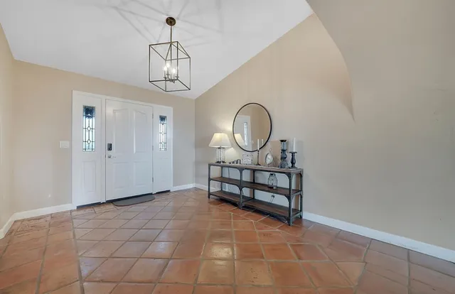 a spacious bathroom with a granite countertop bathtub next to a window