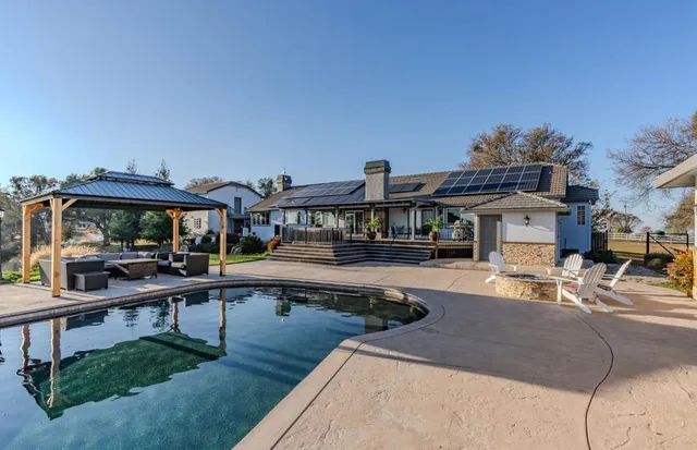 a view of a grassy field with trees