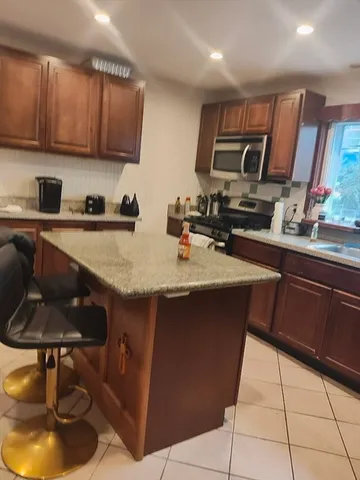 a kitchen with a sink a stove a refrigerator and cabinets